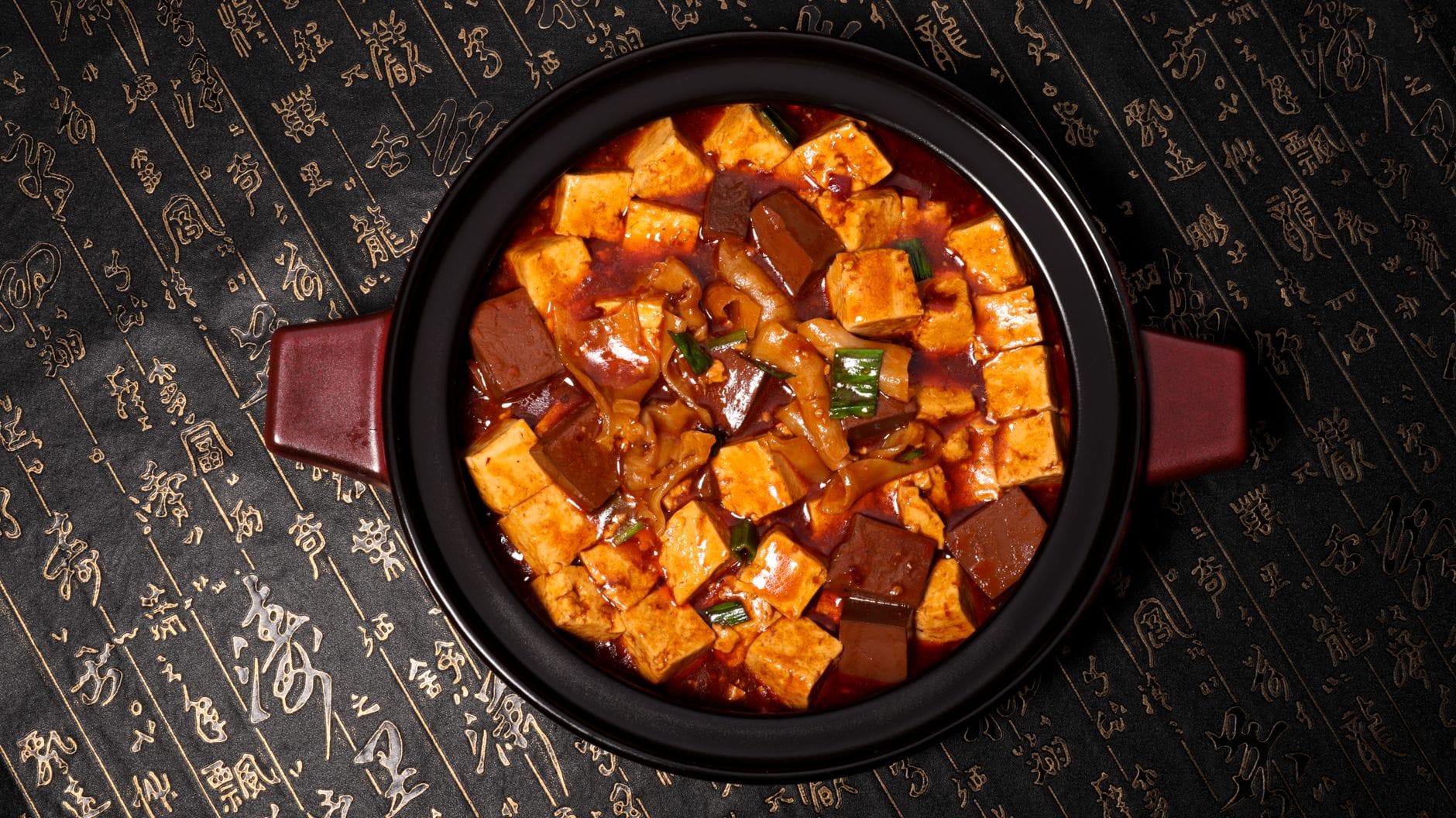 Pikantne mapo tofu w tradycyjnym garnku na orientalnym tle